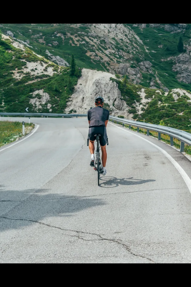 A cyclist on a paved mountain road in China