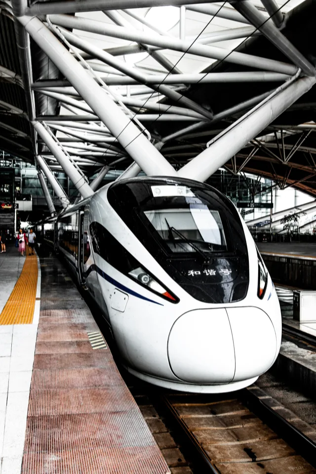 A white Chinese high-speed train at a station platform