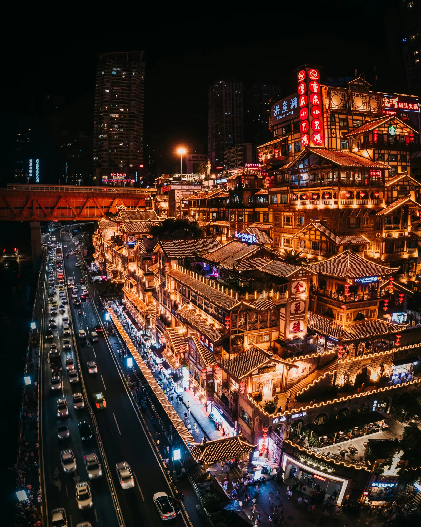 The illuminated stilted houses of Hongya Cave above the river in Chongqing