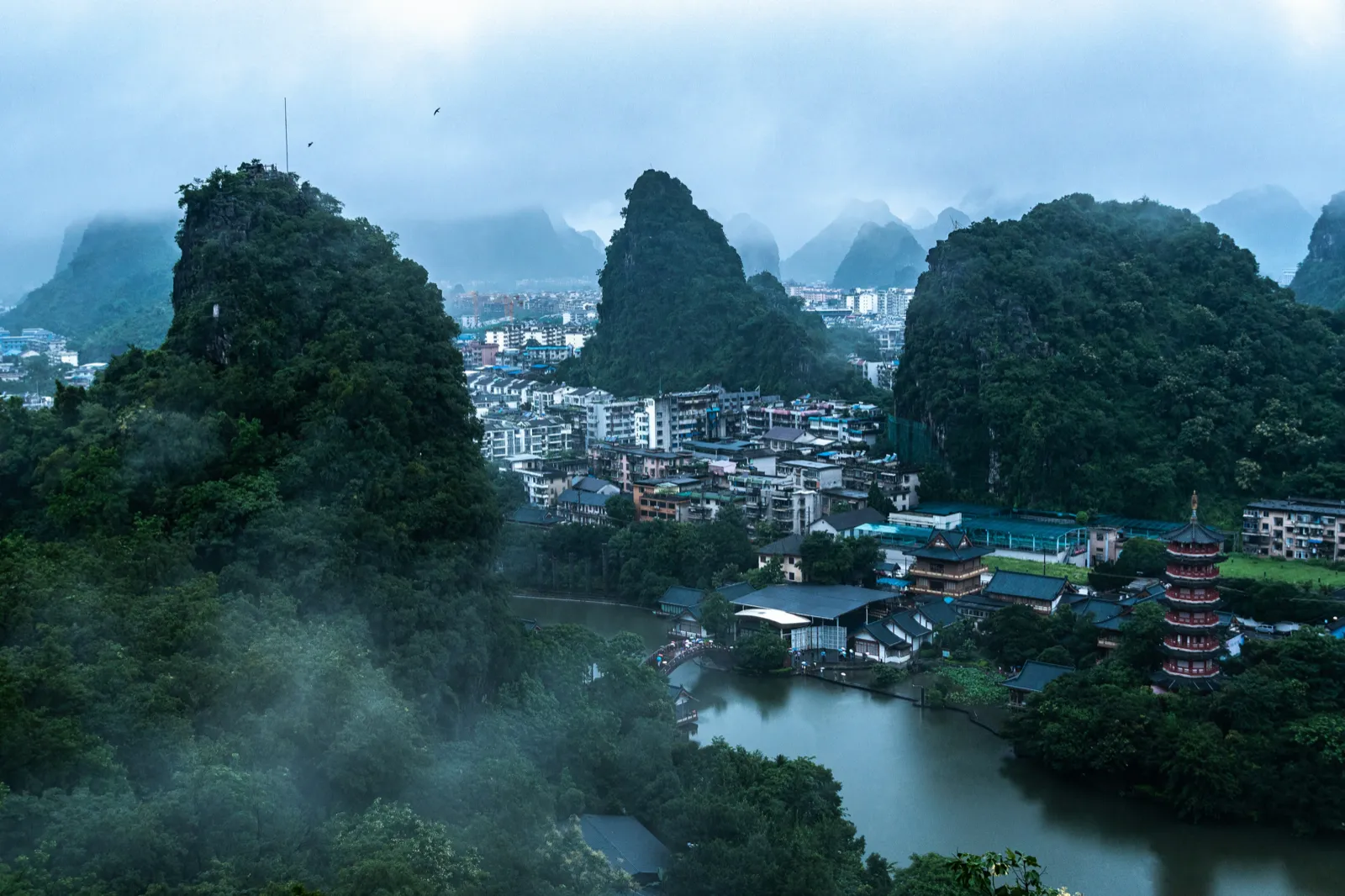 Misty limestone peaks rising over the river in Guilin