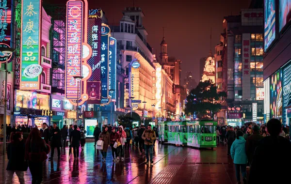 A busy neon-lit shopping street in China at night