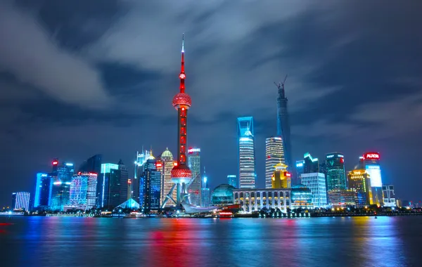 The Pudong skyline lit up at night across the Huangpu River, Shanghai