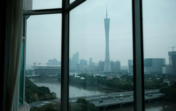 A hotel room window with a view over a Chinese city